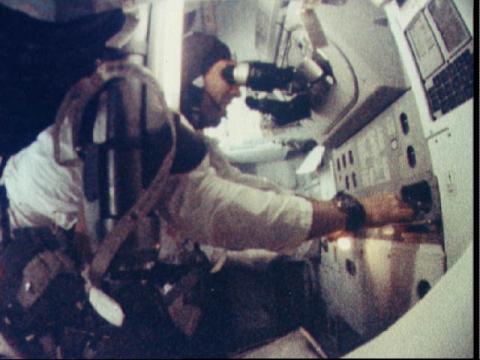 Astronaut James A. Lovell Jr. at the Command Module's Guidance and Navigation station during the Apollo 8 mission