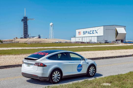 SpaceX's Tesla Model X astronaut transfer vehicle is emblazoned with both NASA's most recent "meatball" and classic "worm" insignia.