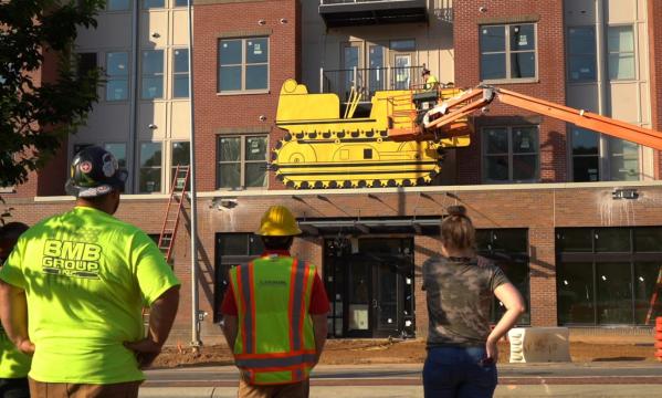 A historic tractor sign is once again hanging over Raleigh's Hillsborough Street.