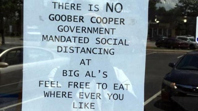 A notice tacked to the door of Big Al's BBQ in Raleigh ignores state regulations on social distancing during the pandemic.