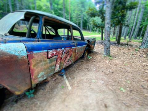 Rusted race cars can still be found in the woods by Occoneechee Speedway.