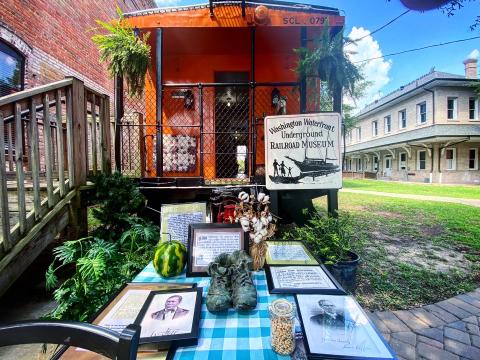 This bright orange railroad car is the location of the Washington Waterfront Underground Railroad Museum, which houses relics and stories from the history of the Underground Railroad network in North Carolina.