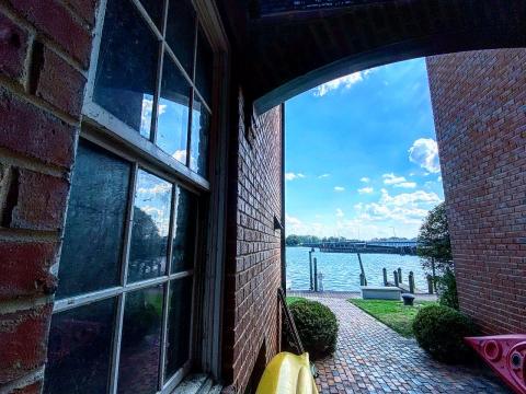 An arched passage leading through Havens Wharf to the Pamlico River on the other side.