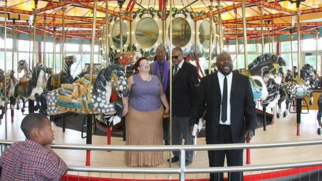 Tim and Lori Truzy had their wedding on the Chavis carousel, symbolic of life's ups and downs, as well as Tim's heritage. Photo by Megan Lyons