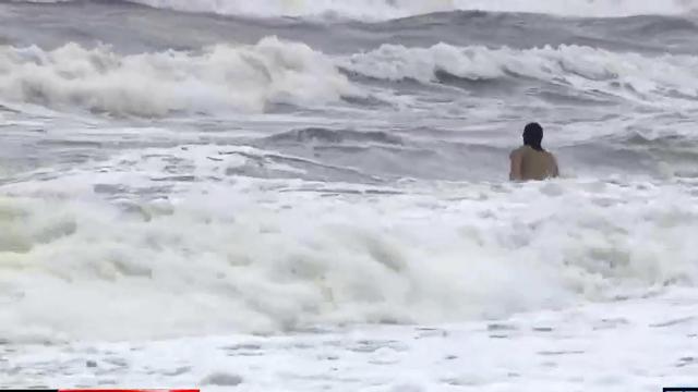 Swimmers brave rough surf on Kure Beach