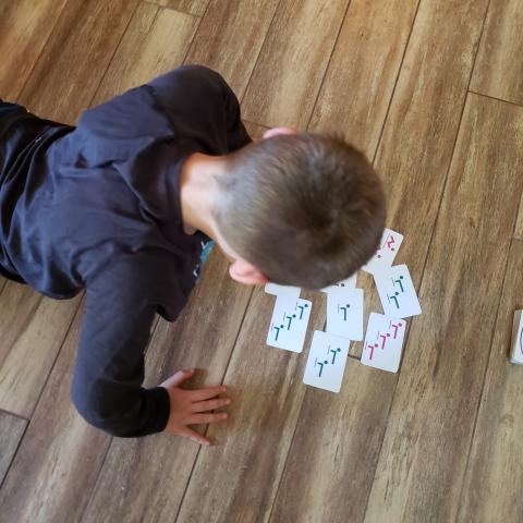 Dan DeJager created Super Fitness Fun Cards to help his students stay stay active in the pandemic. His son Hunter, 10, does push-ups while playing with a deck.
