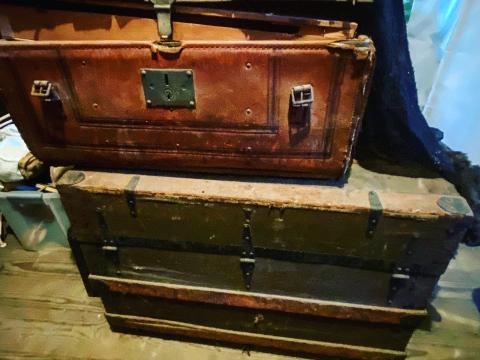 Trunks from the 1800s and early 1900s piled in the attic of Elmwood.