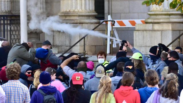 Police pepper spray crowd during march to polls in front of Graham Confederate statue