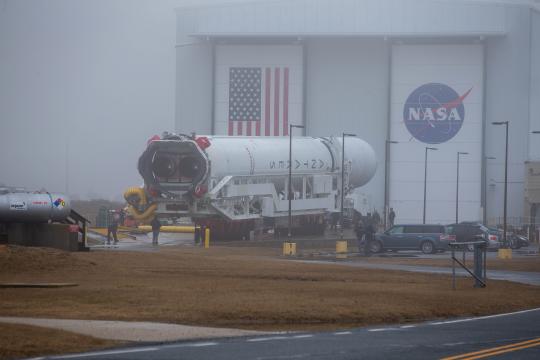 A Northrop Grumman Antares rocket carrying a Cygnus resupply spacecraft is seen as it is rolled out of the Horizontal Integration Facility on its way to the Mid-Atlantic Regional Spaceport’s Pad-0A, Tuesday, Feb. 16, 2021, at NASA's Wallops Flight Facility in Virginia. Northrop Grumman’s 15th contracted cargo resupply mission with NASA to the International Space Station will deliver about 8,000 pounds of science and research, crew supplies and vehicle hardware to the orbital laboratory and its crew. The CRS-15 Cygnus spacecraft is named after NASA mathematician, Katherine Johnson, a Black woman who time and again broke through barriers of gender and race. The launch is scheduled for 12:36 p.m. EST, Feb. 20, 2021. Photo Credit: (NASA/Patrick Black)