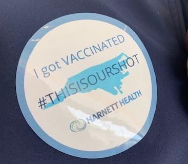 COVID vaccine sticker from Harnett Health.