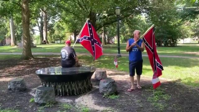 Security expanded around UNC memorial to freed African Americans after men carrying Confederate flags threaten to vandalize it