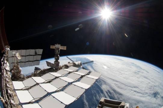 The bright sun, a portion of the International Space Station and Earth's horizon are featured in this image photographed during the STS-134 mission's fourth spacewalk in May 2011. The image was taken using a fish-eye lens attached to an electronic still camera.
