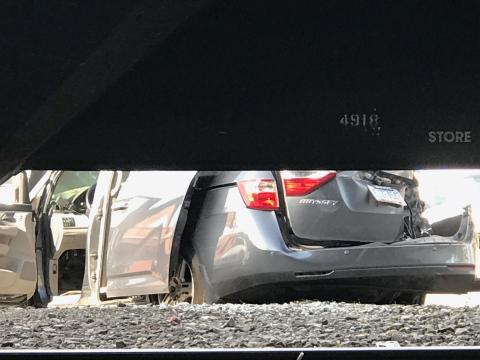 Photos show a minivan crushed underneath the train. 