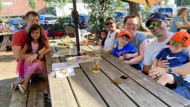 The Sellers family (left) joins the Rietz family (right) at Ponysaurus Brewing Company in Durham. 