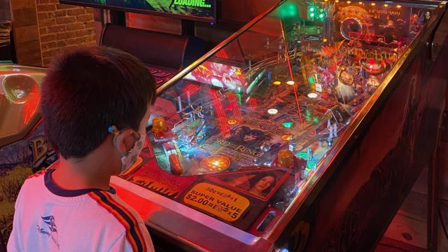 My friends’ son enjoys pinball while wearing his mask at Bowstring Pizza and Brewyard in Raleigh this July. (Amy Davis)

