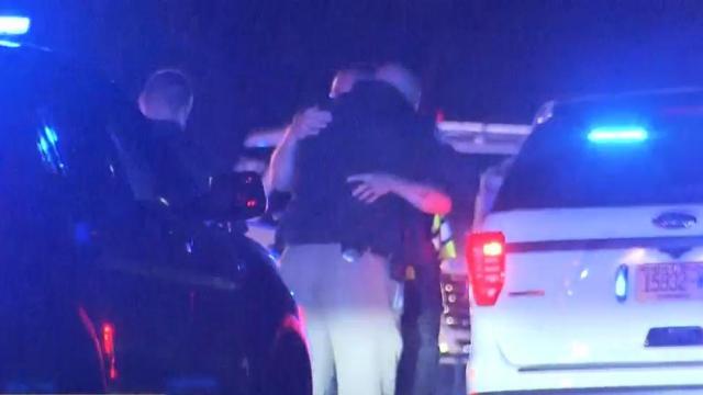 Officers comforting each other after the serious crash.