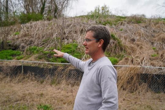 Adam Searing, councilman in Chapel Hill stands outside of the large mound of coal ash near his home in Chapel Hill. 
