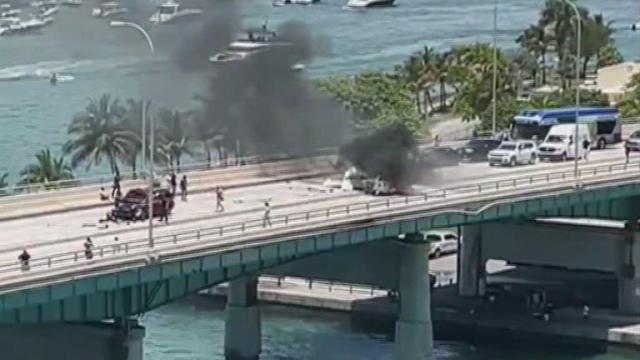 Plane crashes along Miami bridge, burst into flames