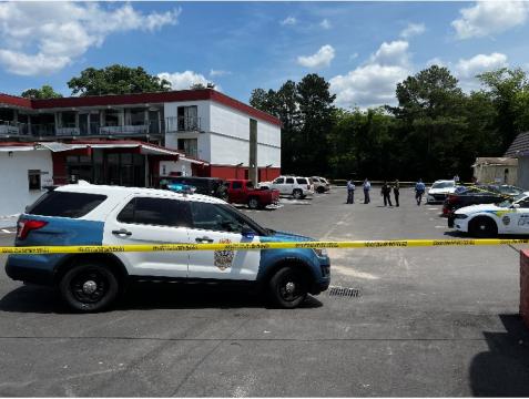 Dozens of police vehicles circled a Days Inn in Raleigh on Tuesday, June 7, 2022