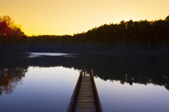 Tranquil scene of dock and water at sunset in North Carolina. Photo: Big Stock