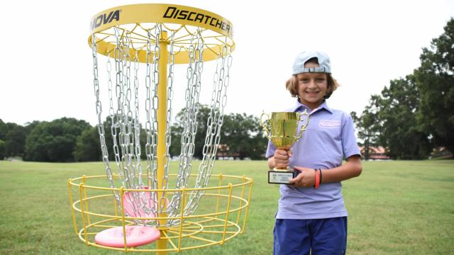 Oliver Beavers, who lives in Raleigh, poses with his disc golf trophy from a world tournament in Peoria, Illinois.