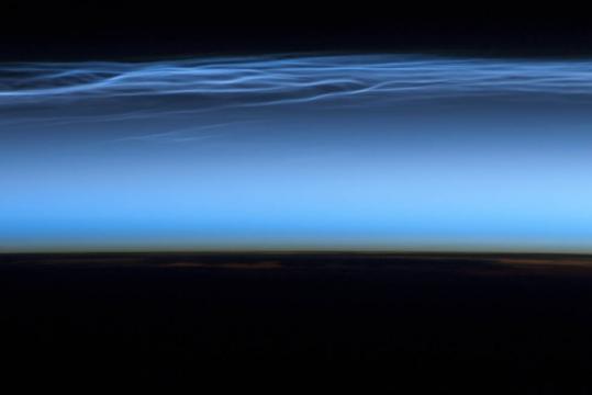Astronauts on board the ISS took this picture of noctilucent clouds near the top of Earth's atmosphere on July 13, 2012.
