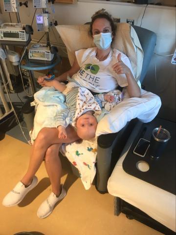 Cole Baranowski receiving treatment on his mother's lap (Courtesy UNC Health Talk)