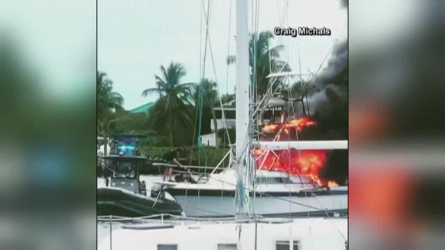 Officers pull unconscious man from burning boat