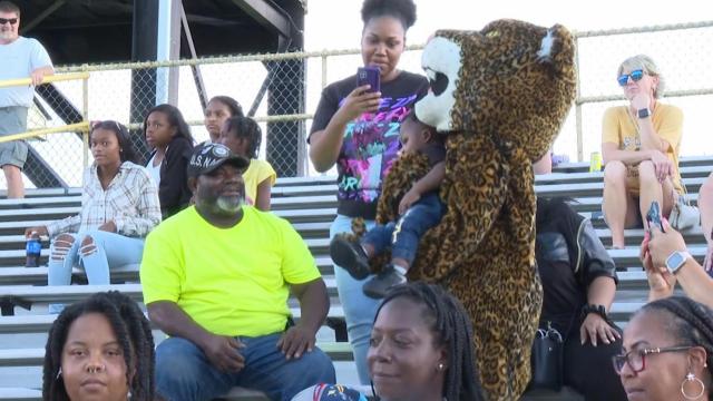 US Navy member returns to high school football game to surprise her dad on his birthday
