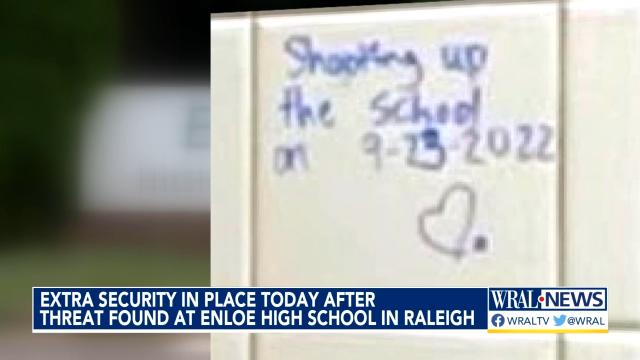 A threat written in blue marker "Shelling of the school on September 23, 2022." with a heart drawn below the message.