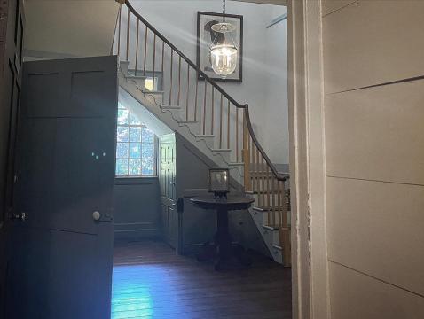 People claim to see a ghostly woman wearing a gray, 1800's-style dress float down a stairwell in the Mordecai House in Raleigh.