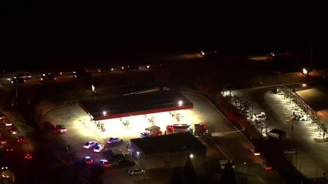 Sky 5 flies over gas station with heavy law enforcement presence