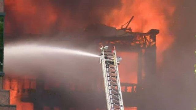 Raw: Flames aggressively rip through construction site, collapsing walls