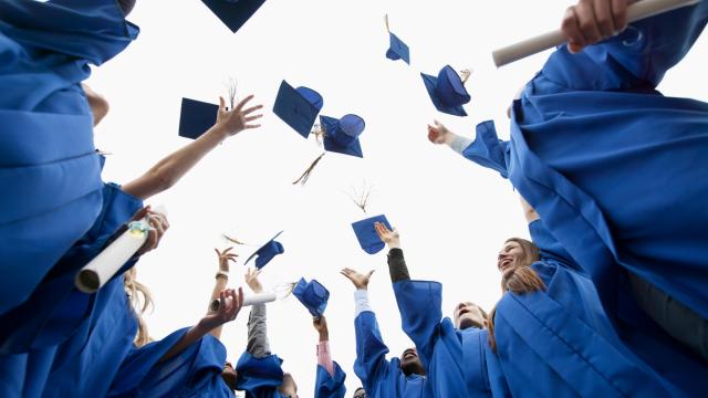 Graduates throwing caps in the air (Adobe Stock/Hero Images)