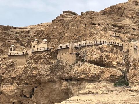 An ancient monastery on the side of a mountain overlooking Jericho