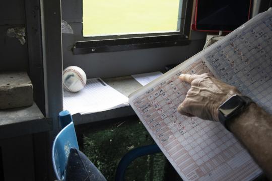 Ivy points to a date on his handwritten scorecard: Photo credit: Margaux Hunter
