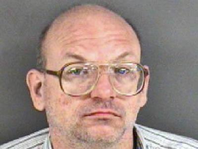 Kenneth Wade Puckett, charged with forging dead father's checks