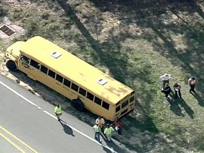 Truck overturns after hitting school bus