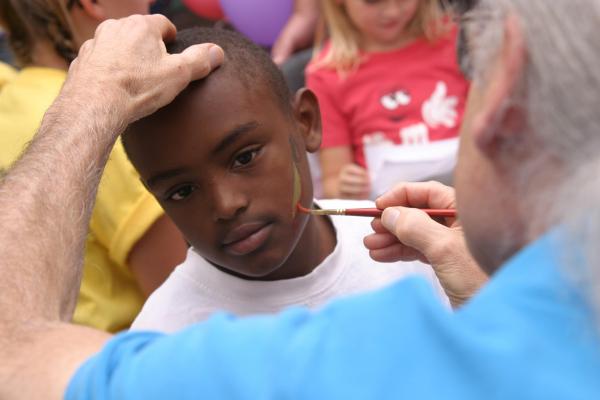 Jaquan Gardner, 12, waits as the last bits of 'blood' are added to the sword on his cheek.