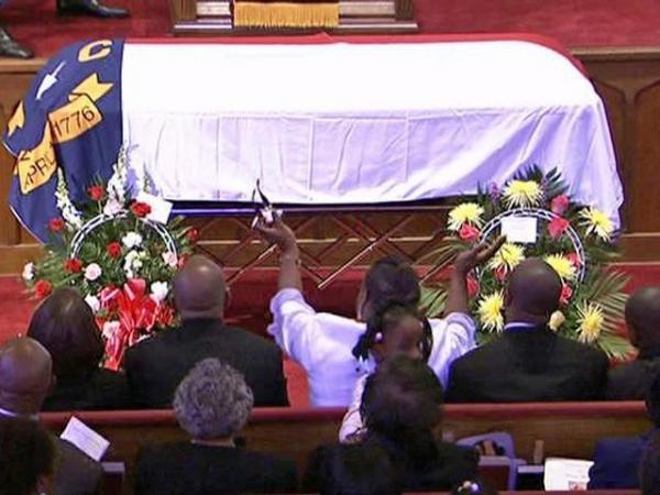 Mourners cheer Malone's life of service