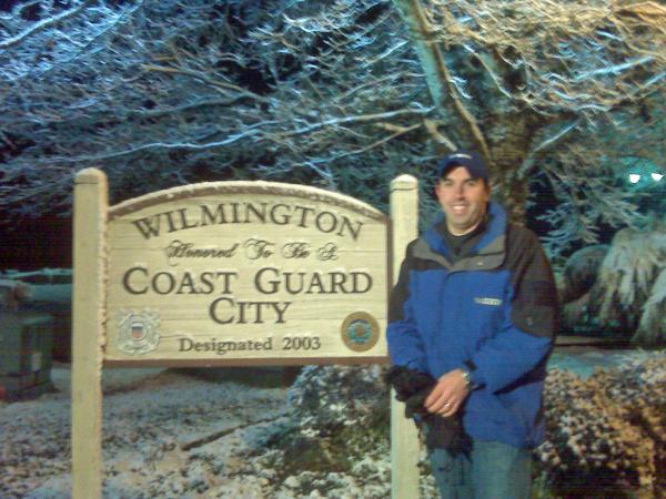 WRAL reporter Mike Charbonneau poses next to a snow covered sign in Wilmington on Saturday, Feb. 13, 2010.