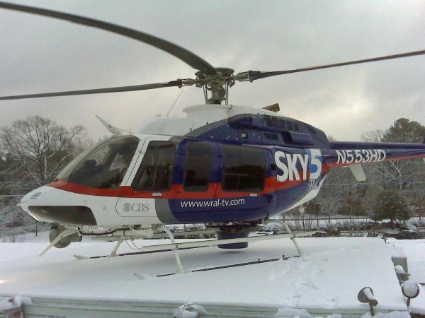 Sky 5 lands on the roof of the WRAL-TV studios after flying over a snow-covered landscape on Saturday, Feb. 13, 2010.