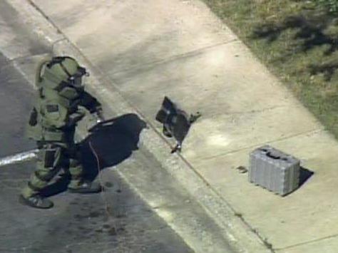 Raw video: Bomb squad member inspects package