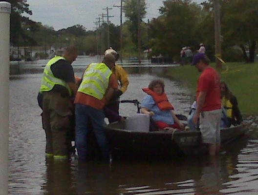Rescuers pluck people from flood waters
